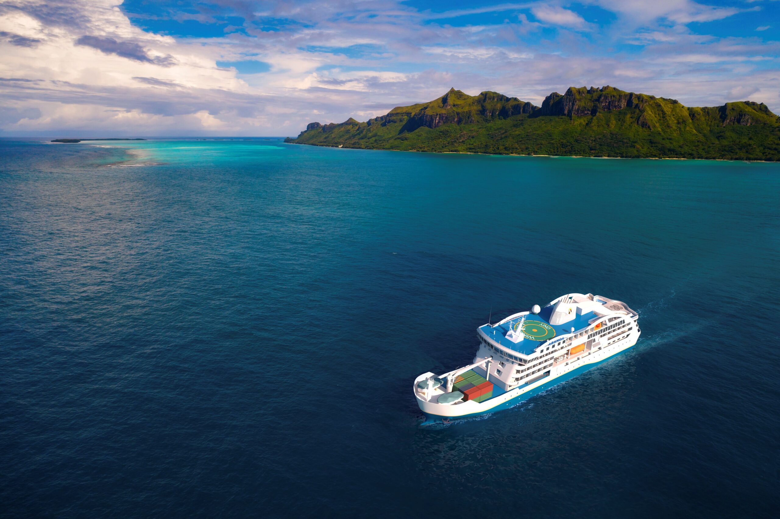 A white cruise ship sailing near a lush, green mountainous island with dramatic coastal terrain