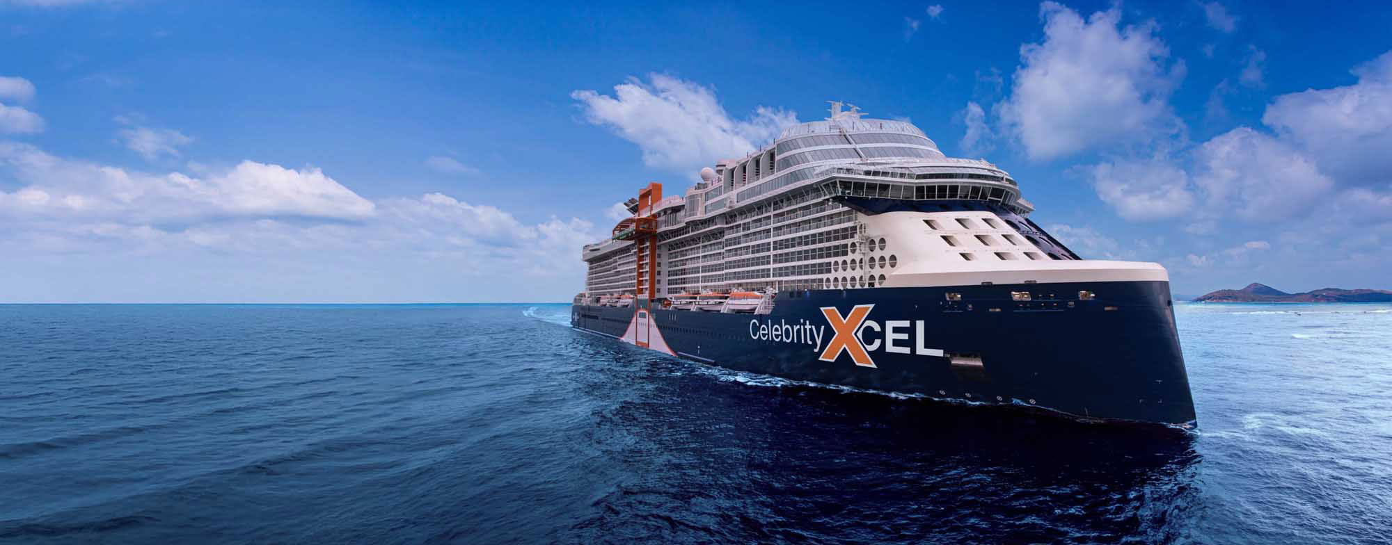 Celebrity Xcel cruise ship anchored in tropical blue ocean waters under clear sky
